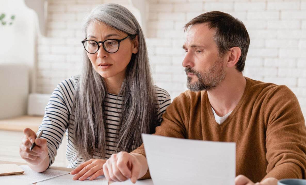 A couple discusses plans over paperwork